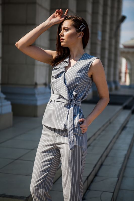 Summer pants suit with striped blouse on gray